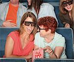 Groups of people in the audience with 3D glasses and laughing