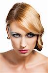 blond beautiful woman with strong make up and an old fashion hair stylish in beauty portrait close up, she is in front of the camera, looks in to the lens with actractive expression