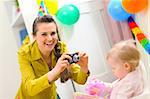 Mother making photos of babys first birthday