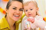 Portrait of mom and baby eating birthday cake