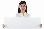 Mixed race Asian woman holding a white board