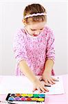 Cute little girl painting with watercolor