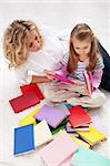 Selecting a story to read - woman and little girl with lots of books