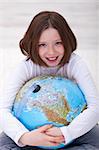 Young girl hugging earth globe - environment concept