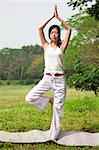 yoga woman  on the grass