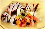 Cherry strudel with ice cream and fruits decorated with chocolate