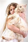 close-up portrait of a little girl holding her Persian breed kitten