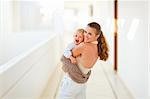 Smiling mother with baby playing outdoor