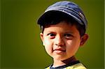 Photo of handsome indian boy with a cap smiling with copy space