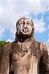 Ancient Buddha statue with blue sky on background