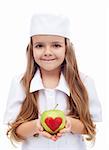 An apple a day keeps the doctor away - little girl in nurse outfit offering apple