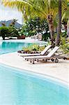 empty deck chairs by the gorgeous pool