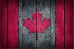 canada flag painted on old wooden background
