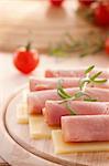 Slices of ham and cheese with rosemary