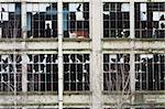 closeup of broken windows of an old factory ruin