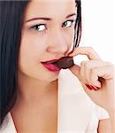close up of woman's lips biting a bar of chocolate in a sexy way