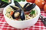 a bowl of spaghetti, mussels and tomato