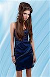 fashion shot of a beauty girl with creative hairstyle wearing a blue elegant dress