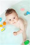 Cute baby looking up while taking a bath