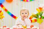 Kid eating first birthday cake