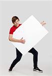 Portrait of a happy young man holding and playing with a blank white card