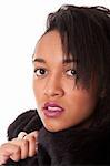 Mulatto young woman in furs on white background