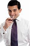 A man drinks wine from a wine glass.  White background.