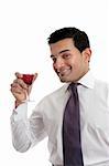 Smiling man raising a glass of wine in celebration.  White background.