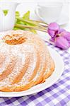 Guglhupf - Traditional Gugelhupf Sponge Cake and Tulip Flowers on Ta