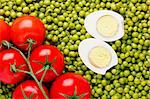 Directly above photograph of red tomatoes and green peas.