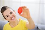 Smiling woman showing red Easter egg