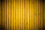 Yellow wood wall background with vignette