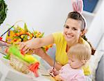 Mother and baby making easter decoration