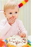Portrait of eat smeared kid eating cake