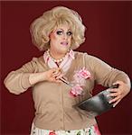 Serious man in drag working with mixing bowl