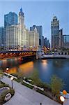 Image of the Chicago riverside downtown district during sunset blue hour.