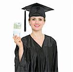 Smiling female graduation student showing pack of euros. HQ photo. Not oversharpened. Not oversaturated