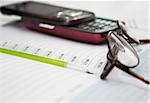 Pen, mobile phone and glasses in composition on a notebook