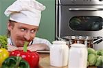 Young chef with vegetables, preparing lunch in kitchen