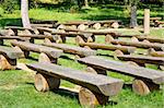 outdoor wood benches on green lawn in sunny day