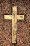 Golden grungy cross op red granite