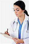 Stock image of female doctor writing on patient chart