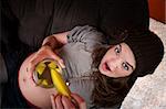 Top view of pregnant woman eating a pickle