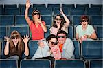 Group of emotional people with 3D glasses in a theater