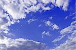 Heaven. Cloudscape of light white clouds around blue sky, warm spring day