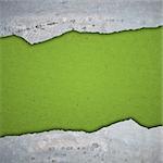 The old green texture of a paper, is decorated in broken off plates. Background in style grunge