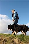 One man and his dog walking side by side