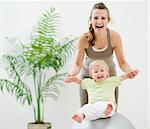 Mother and baby playing with fitness ball