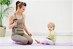 Healthy mother and baby spending time doing fitness