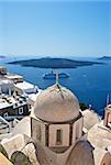 In the foreground is seen a white church steeple with a cross. He towers over the city. At the bottom of the waters of the Mediterranean Sea can be seen an old volcano.